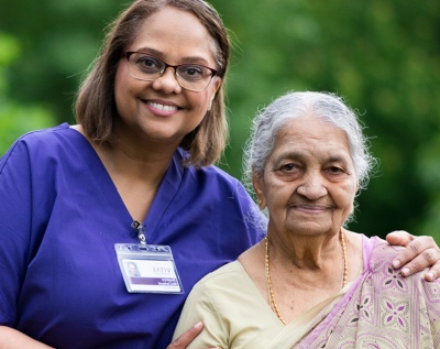 A VITAS nurse and her patient smile