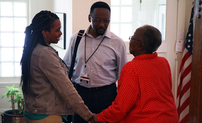 A VITAS social worker talks with a patient and one of her family members